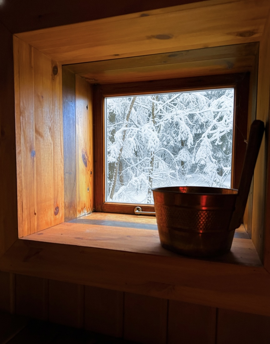 Sauna window with winter view and traditional tea ceremony